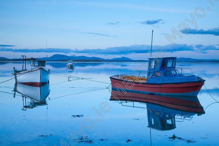 Boats-on-Clew-Bay 
 Fishing boats in Clew Bay, Co Mayo, Ireland. 
 Keywords: Irish, fishing, boats, reflections, reflected, lakes, loughs, lochs, bays, evening, calm, still, tranquil, outdoors, scenery, scenes