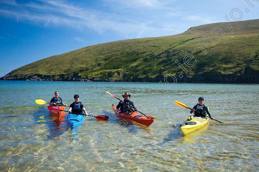 Kayakers-at-the-Blueway-site-at-Keem 
 Sea kayakers in Portacloy Bay, Co Mayo, Ireland. 
 Keywords: Portacloy, bay, County, Mayo, Ireland, activities, activity, adventure, atlantic, boats, canoeing, canoeists, canoes, cliffs, coastal, coastlines, coasts, exploration, Irish, kayakers, kayaking, kayaks, outdoors, pursuits, scenery, scenes, sea, shorelines, shores, sports, water, watersports, beach