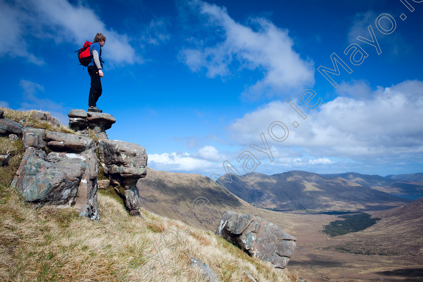 Hill-Walking-in-Mayo 
 Walker on the southeast shoulder of Mweelrea, Co Mayo, Ireland. 
 Keywords: Irish, hills, mountains, peaks, outdoors, scenery, scenes, ridges, hillwalking, walks, walking, walkers, hikes, hiking, hikers, treks, trekking, trekkers, activity, activities, pursuits, person, rocks, rock, pinnacles, views, outlooks