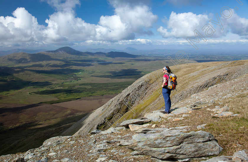 A-Walker-taking-in-the-scenery-in-the-Nephin-Wilderness-Area 
 Walker looking towards Croagh Patrick from Sheeffry East, Sheeffry Hills, Co Mayo, Ireland. 
 Keywords: Irish, hillwalking, walks, walking, walkers, hikes, hiking, hikers, activity, activities, recreation, hills, mountains, peaks, outdoors, scenery, summits, views, Sheefry, scenes, person