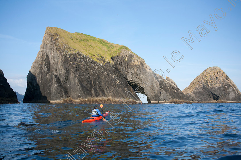 Kayaker-at-the-Staggs-of-Broadheaven-along-the-North-Mayo-Coast 
 Sea kayaker exploring the Stags of Broadhaven, Portacloy, Co Mayo, Ireland. 
 Keywords: Irish, sea, kayaking, kayaks, kayakers, canoeing, canoes, canoeists, boats, water, sports, watersports, adventure, exploration, activity, activities, outdoors, pursuits, shores, shorelines, coasts, coastlines, coastal, atlantic, outdoors, scenery, scenes, cliffs, rocky, islands, caves, arches, natural