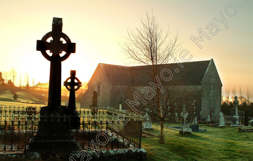 Ballintubber Abbey 
 Celtic crosses stand silent in the grave yard of ballintubber Abbey as the winter sun rises. Pic: Michael Mc Laughlin