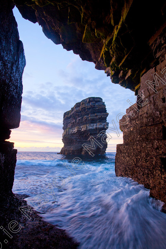 Downpatrick-Head-at-North-Mayo-Coast 
 Dun Briste from Downpatrick Head sea cave, Co Mayo, Ireland. 
 Keywords: Irish, sea, cliffs, seacliffs, clifflines, shores, shorelines, coasts, coastlines, coastal, atlantic, seas, oceans, outdoors, landscapes, scenery, scenes, headlands, stacks, seastacks, sheer, rocks, rocky, caves, caverns, evening