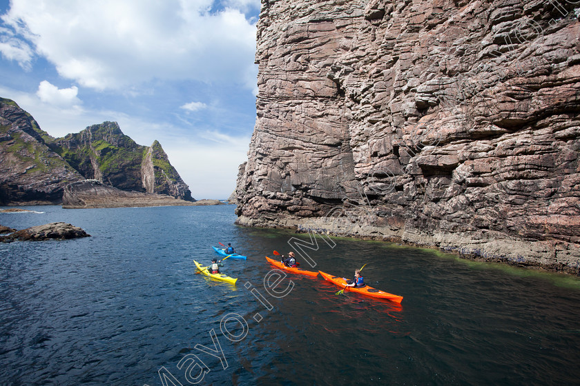 Kayakers-along-the-coast-at-North-Mayo 
 Sea kayakers passing Hag Island, North Mayo seacliffs, Co Mayo, Ireland. 
 Keywords: Hag, County, Mayo, Ireland, activities, activity, adventure, atlantic, boats, canoeing, canoeists, canoes, cliffs, coastal, coastlines, coasts, exploration, Irish, kayakers, kayaking, kayaks, outdoors, pursuits, scenery, scenes, sea, shorelines, shores, sports, water, watersports, rock, rocky, islands, seacliffs