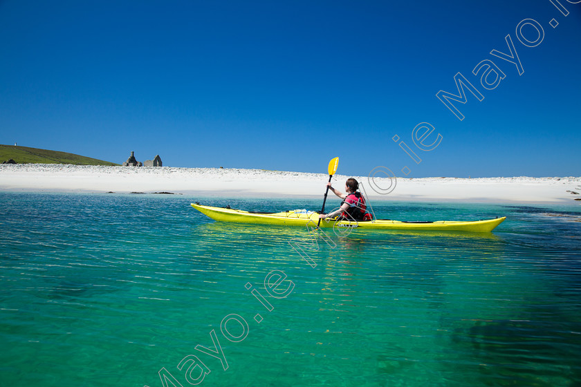 Kayaker-at-Iniskea 
 Sea kayaking beside Inishkea South Island, County Mayo, Ireland. 
 Keywords: Irish, island, islands, Inishkeas, Inishkea, Connaught, Connacht, uninhabited, remote, offshore, outdoor, outdoors, scenery, scene, scenes, atlantic, sea, ocean, coast, coastline, coasts, coastlines, coastal, beach, beaches, sand, sandy, strands, strand, shore, shoreline, shorelines, kayaking, kayaker, kayakers, kayak, kayaks, boat, boats, water, sports, watersports, adventure, exploration, exploring, explore, person, people, canoes, canoeists, paddlers, activity, activities, pursuit, pursuits, paddling, turquoise, water, summer, white