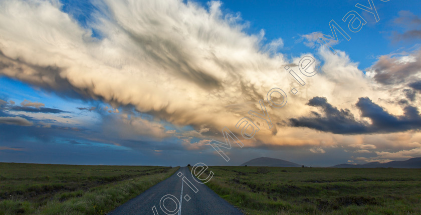 Wild-Atlantic-Way-at-Ballycroy 
 Big sky country, Ballycroy National Park, County Mayo, Ireland. 
 Keywords: Irish, hills, landscapes, outdoors, scenery, scenes, bog, bogland, land, moor, moorland, parks, sky, clouds, space, wilderness, remote, road, lane, travelling, travels, car, roads, journey, journeys, trips