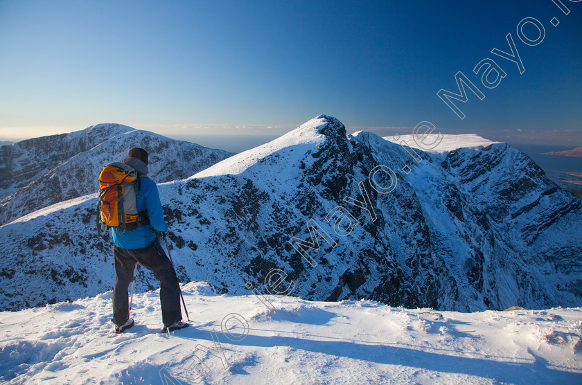 Winter-Scene-in-the-Nephin-Wilderness-Area-(0001) 
 Winter walker near the summit of Mweelrea, Co Mayo, Ireland. 
 Keywords: Irish, hills, mountains, peaks, outdoors, scenery, scenes, ridges, hillwalking, walks, walking, walkers, hikes, hiking, hikers, winter, snow, snowy, summits, activity, activities, pursuits, person, views, Connemara, seasons